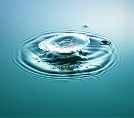 Water drop photography, one or two drops of water dropped from height into water and captured as...