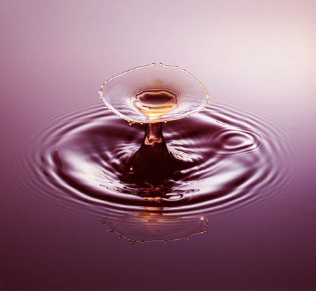 Water drop photography, one or two drops of water dropped from height into water and captured as they hit the water or collide with each other.の写真素材