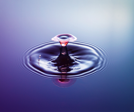 Water drop photography, one or two drops of water dropped from height into water and captured as they hit the water or collide with each other.の写真素材