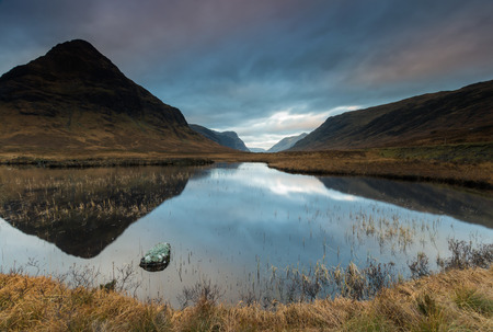 Mountain reflecting in water near Ballachulish, Glencoe, Scotlandの写真素材