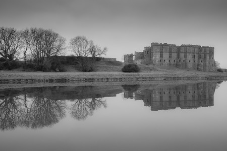 Carew Castle reflecting in the water on a misty morning, Pembrokeshireの写真素材