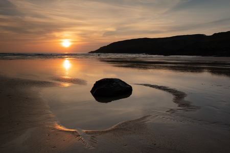Angle Bay, Pembrokeshire, with pools of water as the sun goes downの写真素材