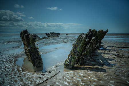 SS Nornen Shipwreck, Somerset reflecting in pools of water on a sunny dayの写真素材