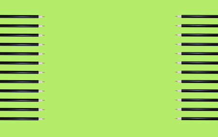 Pattern with ballpoint school pens on the edges in the form of a frame on a green background. Prints...