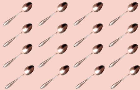 Pattern with a steel spoon on a beige background. Prints, templates.の写真素材