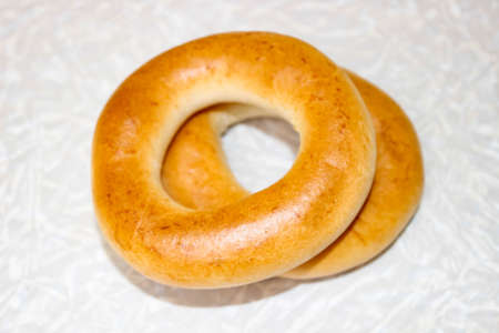 Two bagels for tea on the light surface of the table. Selective focusの写真素材