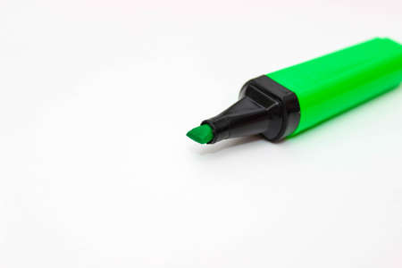 Green marker text highlighter on a white background. Selective focus.の写真素材