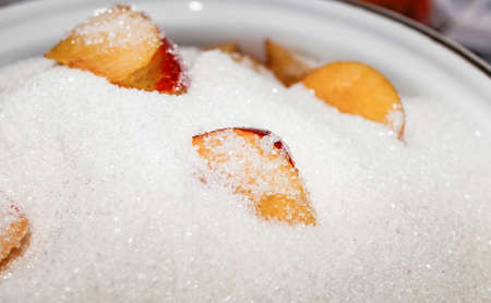 Fresh apples covered with sugar in a saucepan, for making jam. Close-up, selective shot.の写真素材