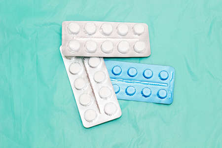 Round Tablets in packages of different sizes. Close up.