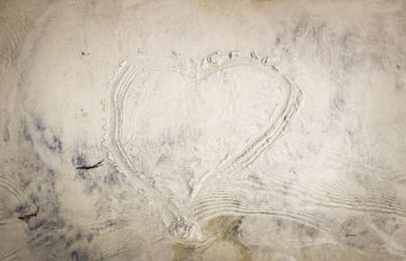 Heart drawn on the sand on the beach. The view from the top.
