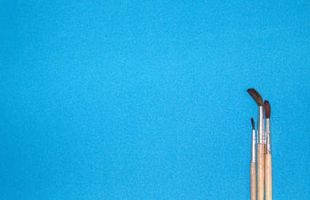 Watercolor artist's brushes on a blue paper background. Banner, template. Space for text.の写真素材