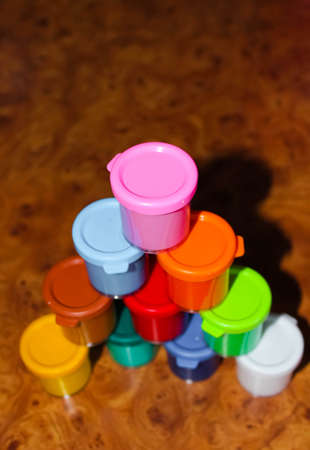 Pyramid built from colored jars with gouache. Selective shot.の写真素材