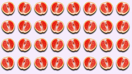 Fruit pattern of half a grapefruit with a shadow on a light background. Citrus pattern for patterns, prints.の写真素材