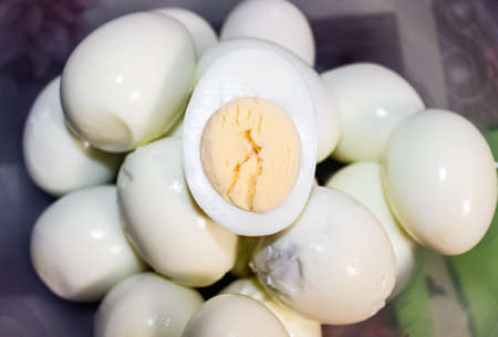 A few Homemade boiled eggs that are peeled from the shell. Top view, selective shot.