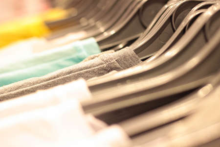 Clothes hanging on the shelves in the store. Shopping on site.