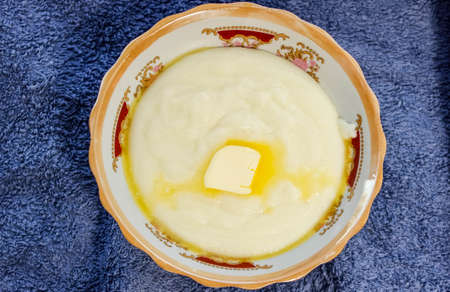 Delicious Hot semolina porridge with butter in a plate. The view from the topの写真素材