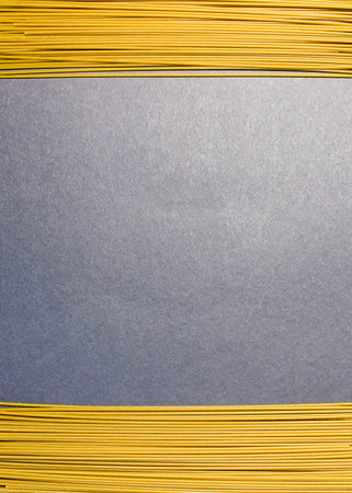 Raw thin spaghetti on a black background. Frame, space for text. Copy space. The vertical frame.の写真素材