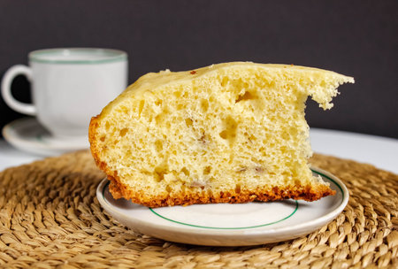 Cut a piece of fresh sponge cake on a saucer. baking for tea