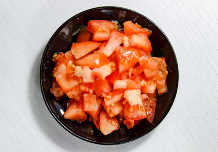 Put the ripe tomatoes on a plate, which is finely chopped. The view from the top.