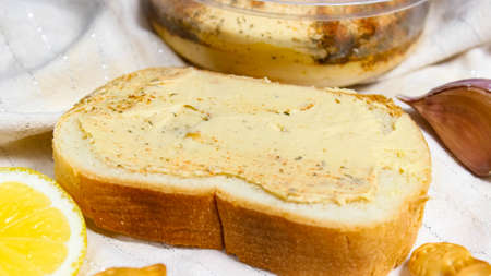 White bread smeared with hummus close-up.