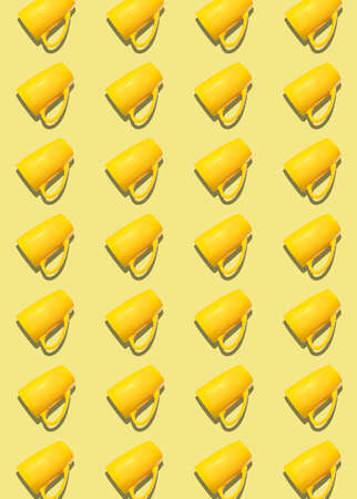 A pattern of yellow cups on a light yellow background. Vertical Pattern, prints, copyspace.の写真素材