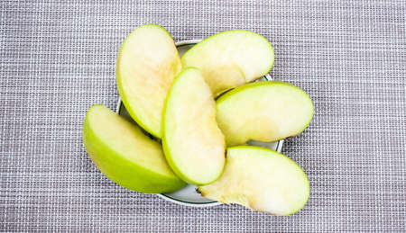 Green apple slices are in a saucer. Dietary nutrition, detox. Top view.の写真素材