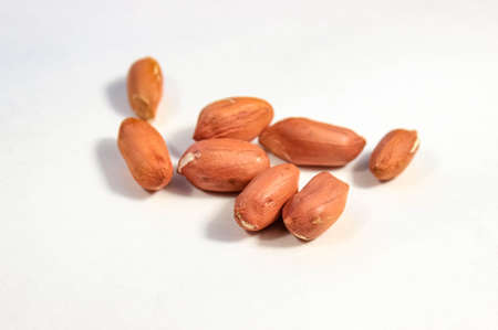 Peeled peanut beans close up on a white background. Selective shot.