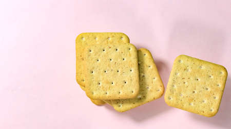 Cookie cracker close-up on a pink background. Top view.