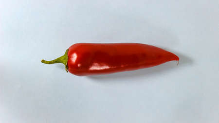 Red bell pepper on a blue paper background. Fresh vegetables. Top view.の写真素材