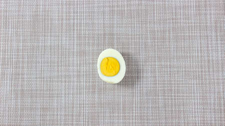 One half of a boiled egg cut off. Top view.の写真素材