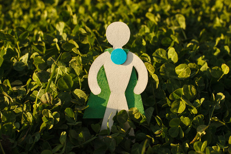 Eco symbol - Man of cardboard on the grass. Environment protectionの写真素材