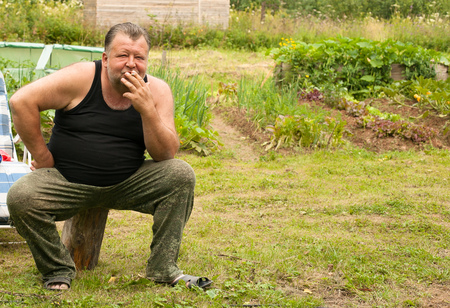 A man sitting around the house in the garden on a sunny day. Vacation Conceptの写真素材
