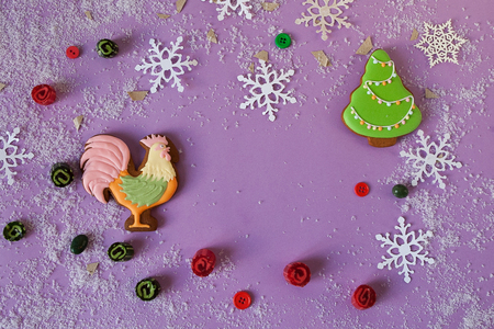 New year background with gingerbread cock, snowflakes and fir. Top view with copy spaceの写真素材