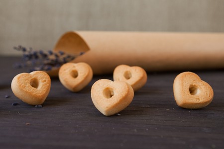 Heart cookies with lavender on a wooden brown background.の写真素材