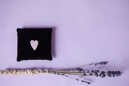 Heart made of purple paper on the small soft pillow with lavender. Concept of Valentine Day, top view. Copy space for textの写真素材