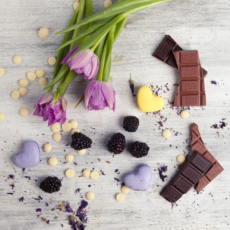 Valentines Day background. Heart shaped cookies and chocolate with tulips on the wooden background. Top viewの写真素材