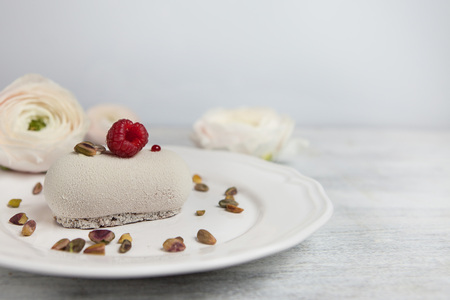 Cake with raspberry and flowers, copy spaceの写真素材