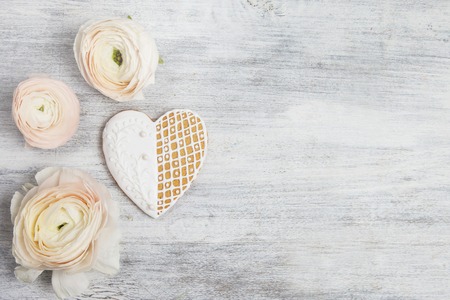 Heart shaped gingerbread cookie with peoniesの写真素材