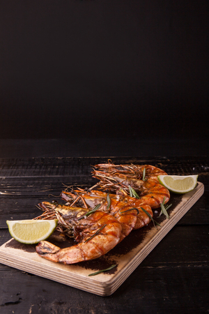 Fried big tiger shrimp on the wooden cutting boardの写真素材