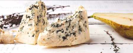 Soft blue cheese with pear on wooden background. Close up.の写真素材