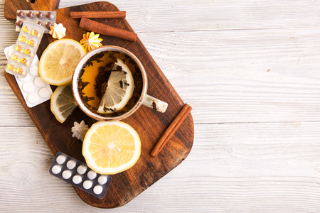 Herbal tea with lemon and pills . Healthcare Conceptの写真素材
