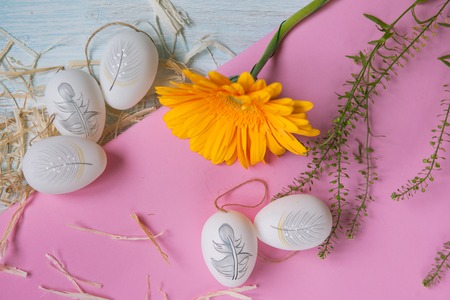 Easter eggs with flowers on the pink background