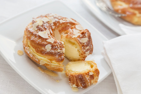 Eclairs with vanilla cream and almonds