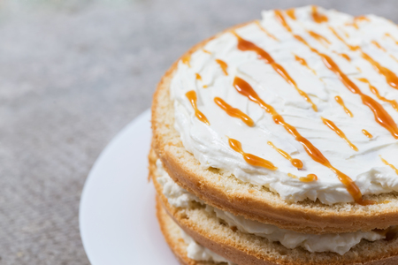 Sponge cake with cream cheese and caramel. Cooking processの写真素材