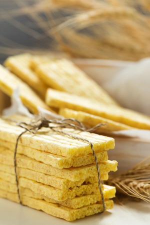 Wholegrain crispbreads and ears of wheat. Healthy food. Close up, selective focusの写真素材
