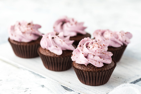 Chocolate cupcakes with berry cheese creamの写真素材