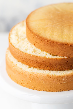 Sponge cake. Shortcakes on a white cake stand, selective focusの写真素材