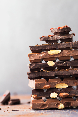 Chocolate tower. Dark and milk chocolate bars with nutsの写真素材