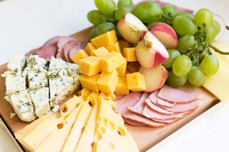 Cheese board with fruits and meat. Close up, selective focusの写真素材