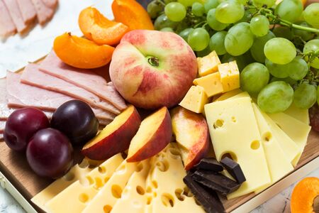 Cheese board with fruits and meat. Close up, selective focusの写真素材